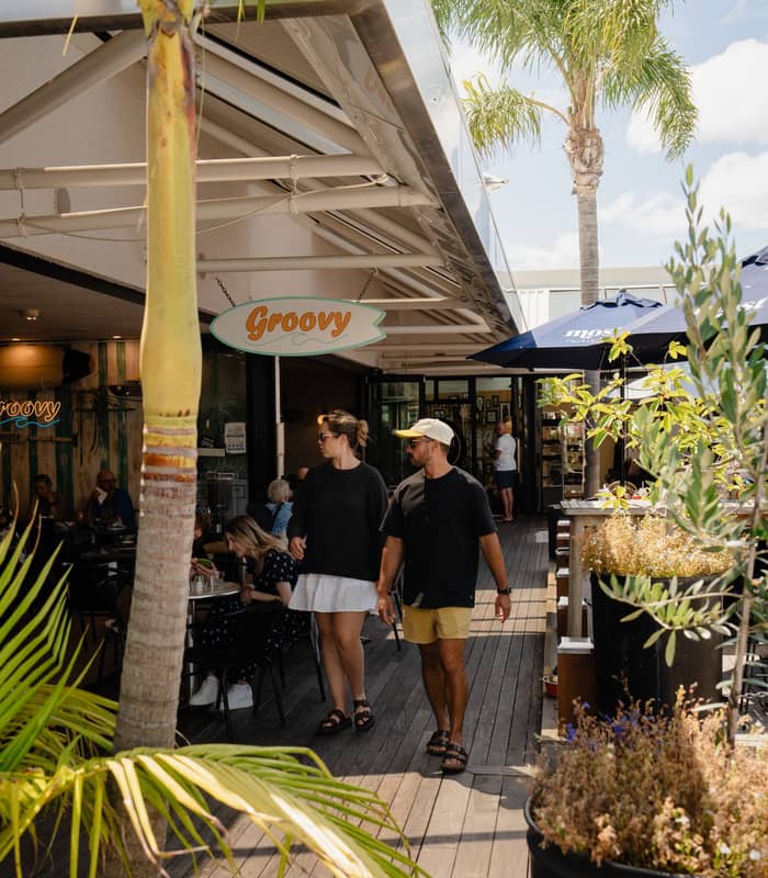 Couple shopping in Mount Maunganui main street.