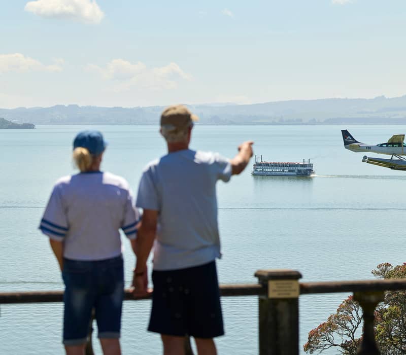 Couple watching float plane land at On The Point