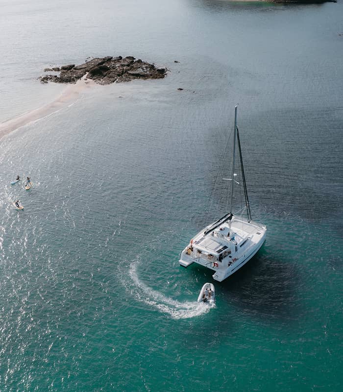 Aerial view of yacht charter and paddleboarding in the Bay of Islands.